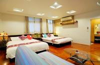 a hotel room with two beds and a table at Nature House Homestay in Dongshan