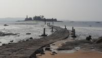 a walkway leading into the water on a beach at Zhu Shan Grandee B&amp;B in Jincheng