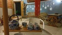 a room with a table with blue and white vases on a shelf at Zhu Shan Grandee B&amp;B in Jincheng