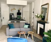 a living room with a couch and a fireplace at Magnifiques Appartements Hyper Centre in Nantes