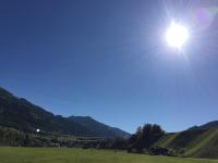 a field with the sun in the sky at Apartment Hermine in Jochberg