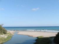 a beach with a body of water and the ocean at Kenting Tuscany Resort in Kenting