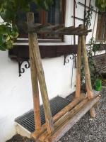 a wooden bench sitting outside of a window at Apartment Hermine in Jochberg