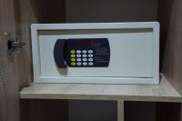 a microwave with a phone inside of it on a shelf at Renion Park Hotel in Almaty