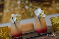 a table with three cocktails with flowers in them at De Vesten Comfort Lodge in Laakdal