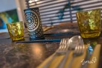 a table with a fork and two glasses on it at De Vesten Comfort Lodge in Laakdal