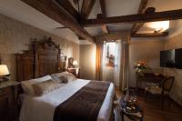 a bedroom with a large bed and a television at Palazzo Bembo - Exclusive Accommodation in Venice
