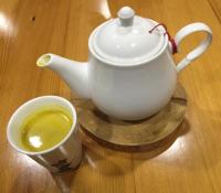 a tea pot and a cup of coffee on a table at Bei Yue B&amp;B in Luodong