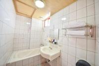 a white bathroom with a sink and a bath tub at Beverly B&amp;B in Ren&#39;ai