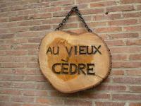 a wooden sign that says all view coffee hanging on a brick wall at au vieux cèdre in Mouvaux