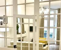 a living room with white furniture and windows at Magnifiques Appartements Hyper Centre in Nantes