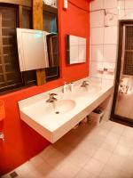 a bathroom with two sinks and a red wall at Corner Inn九份住宿I 小角落民宿I 機車租借I日夜間導覽 in Jiufen