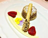 a plate of food with a pastry and strawberries at Le Rocher Hotel in Champoluc