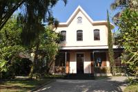 una casa blanca con árboles delante en Hotel Casablanca Koeler, en Petrópolis