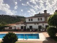 a house with a swimming pool in front of it at Hotel El Paso in Vejer de la Frontera