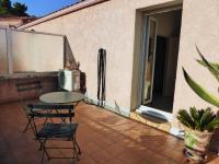 a patio with a table and chairs and a window at 4SAP22 Appartement climatisé avec double terrasses in Collioure