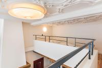 a staircase with a white ceiling and a chandelier at Hotel Agora Brussels Grand Place in Brussels