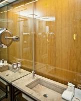 a bathroom with a shower and a sink at CORTIINA Hotel in Munich