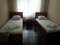 A bed or beds in a room at Kanclera Hotel