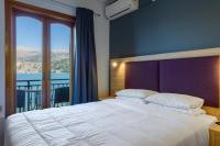 A bed or beds in a room at Hotel Aggelos Kefalonia