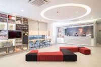 a room with two beds and a tv in a store at Red Planet Manila Bay in Manila