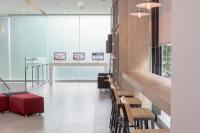 a lobby with a waiting area with a red suitcase at Red Planet Manila Bay in Manila
