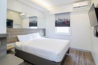 a bedroom with a large white bed in a room at Red Planet Manila Bay in Manila