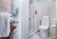 a bathroom with a toilet and a shower at Red Planet Manila Bay in Manila