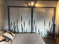 a bedroom with a bed with tall grass on the wall at Les Yeux Bleus Bed &amp; Breakfast in Noirmoutier-en-l&#39;lle