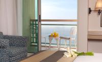 a room with a bed and a table with candles on it at Herods Palace Hotels & Spa Eilat a Premium collection by Fattal Hotels in Eilat