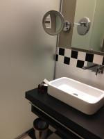a bathroom with a white sink and a mirror at Villa Élyane in Colmar