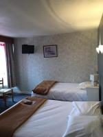 a hotel room with two beds and a flat screen tv at Hotel du Rempart in Sancerre
