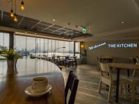 a cup of coffee sitting on a table in a restaurant at Watermark Hotel - Sizihwan in Kaohsiung