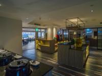 a lobby of a restaurant with a bar and tables at Watermark Hotel - Sizihwan in Kaohsiung