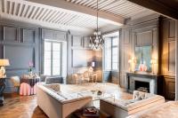 a living room with a couch and a fireplace at Château de Pierreclos in Pierreclos