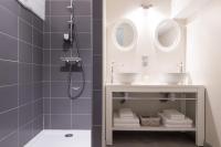a bathroom with two sinks and a shower at Château de Pierreclos in Pierreclos