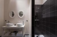 a bathroom with two sinks and a shower at Château de Pierreclos in Pierreclos