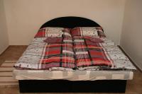 A bed or beds in a room at Penzion Atlas