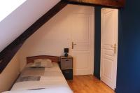 a bedroom with a bed in a attic at Gîte La Loussaudrie in Pontmain