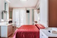 A bed or beds in a room at Hotel Villa Pina