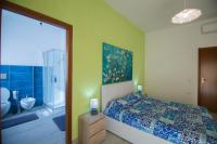 A bed or beds in a room at Sandalia B&B