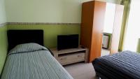 a bedroom with a bed and a flat screen tv at Aparthotel Résidence Bara Midi in Brussels