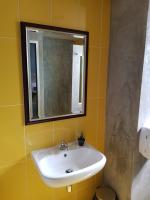 a bathroom with a sink and a mirror at Baan Baimai Boutique Room in Phra Nakhon Si Ayutthaya