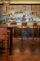 a boy sitting at a bar in a restaurant at Four Seasons Hotel Buenos Aires in Buenos Aires
