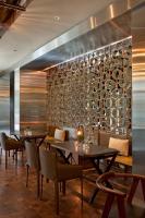 a restaurant with tables and chairs and a wall with plates at Four Seasons Hotel Buenos Aires in Buenos Aires
