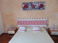 A bed or beds in a room at Appartamenti Budoni