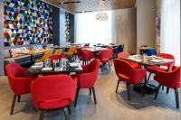 a dining room with tables and red chairs at Hyatt Regency Bloomington - Minneapolis in Bloomington