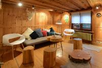 a living room with a couch and wooden walls at KAYSERSBERG city center - House &quot;AUX 7 FORGERONS&quot; - in Kaysersberg