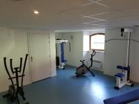 a room with a gym with exercise equipment in it at Résidence Grand Hôtel in Aulus-les-Bains