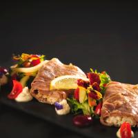 un plato de comida con carne y ensalada en Hotel Pagony Wellness, en Nyíregyháza